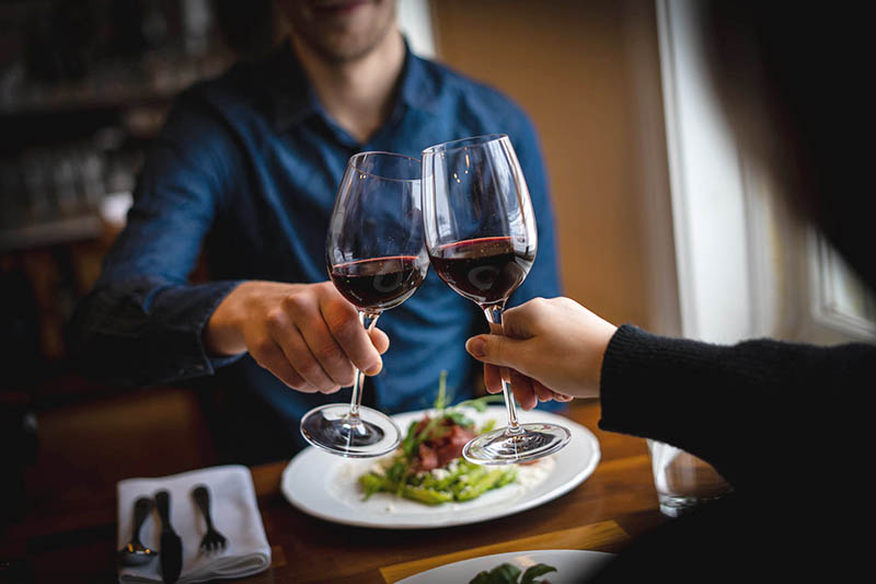 Couple toasting with red wine Ravintola Sergio